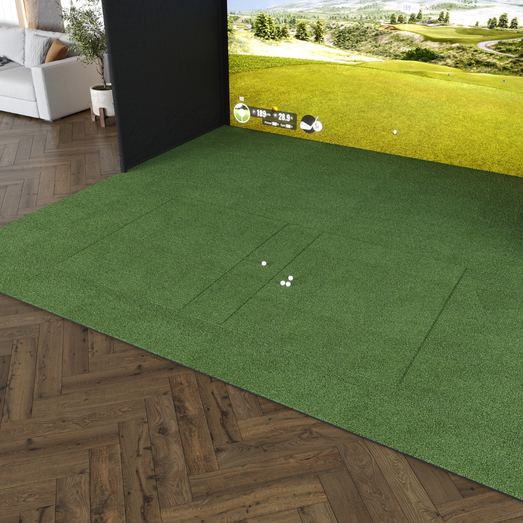 Indoor golf simulator setup with putting turf, hitting mat, and impact screen.