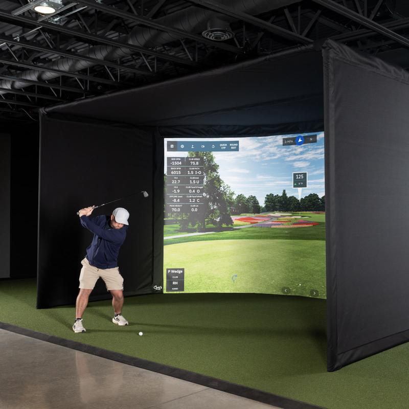 Carls Place Curved Golf Simulator Enclosure Kit with golfer swinging.