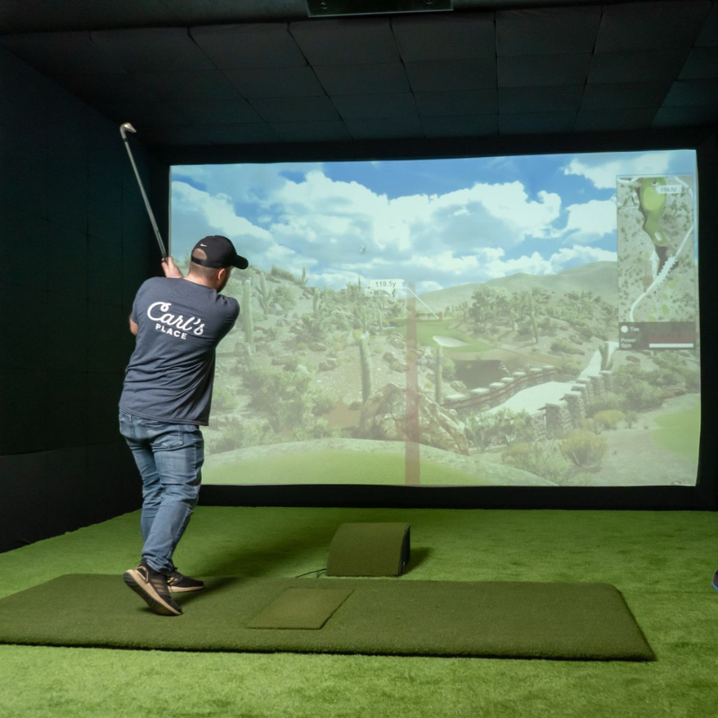 Carl&#39;s Place Floor Mounted Projector Enclosure with golfer swinging in simulator.