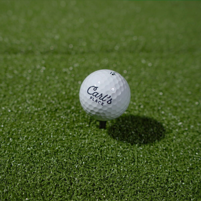 Carls Place HotShot Golf Mat System  with golf ball and tee.