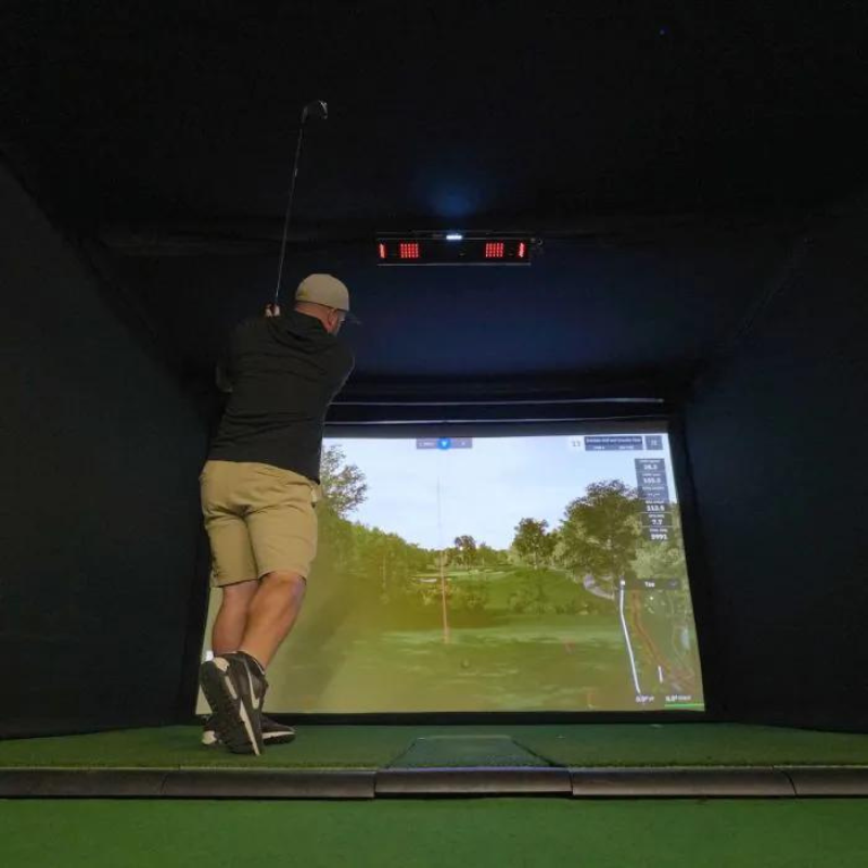 Carl&#39;s Place Uneekor EYE XO2 Protective Case installed in golf simulator with golfer swinging.