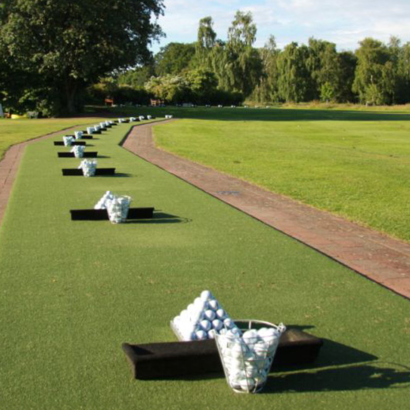 EZTee Poly Golf Hitting Mat And Tee Line Turf golf driving range setup with mats and ball baskets.