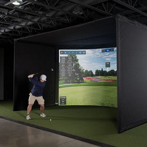 Carl's Place Curved Golf Simulator Enclosure Kit with Impact Screen and golfer practicing.