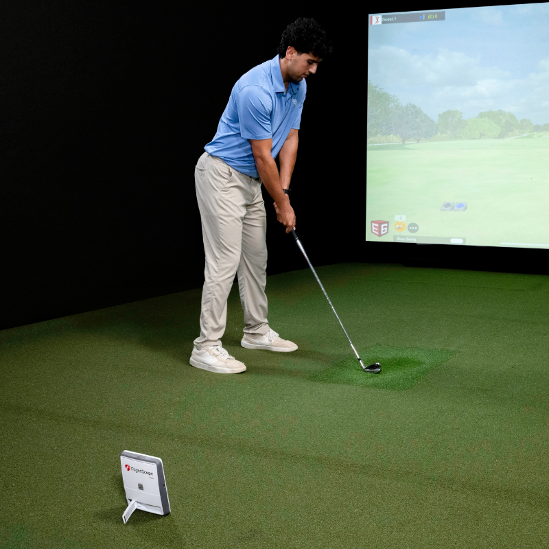 FlightScope Mevo Gen2 Launch Monitor man teeing up inside.