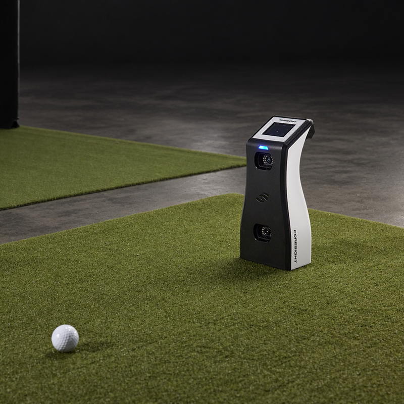 Foresight Sports GC2 Launch Monitor on simulator turf with a golf ball.