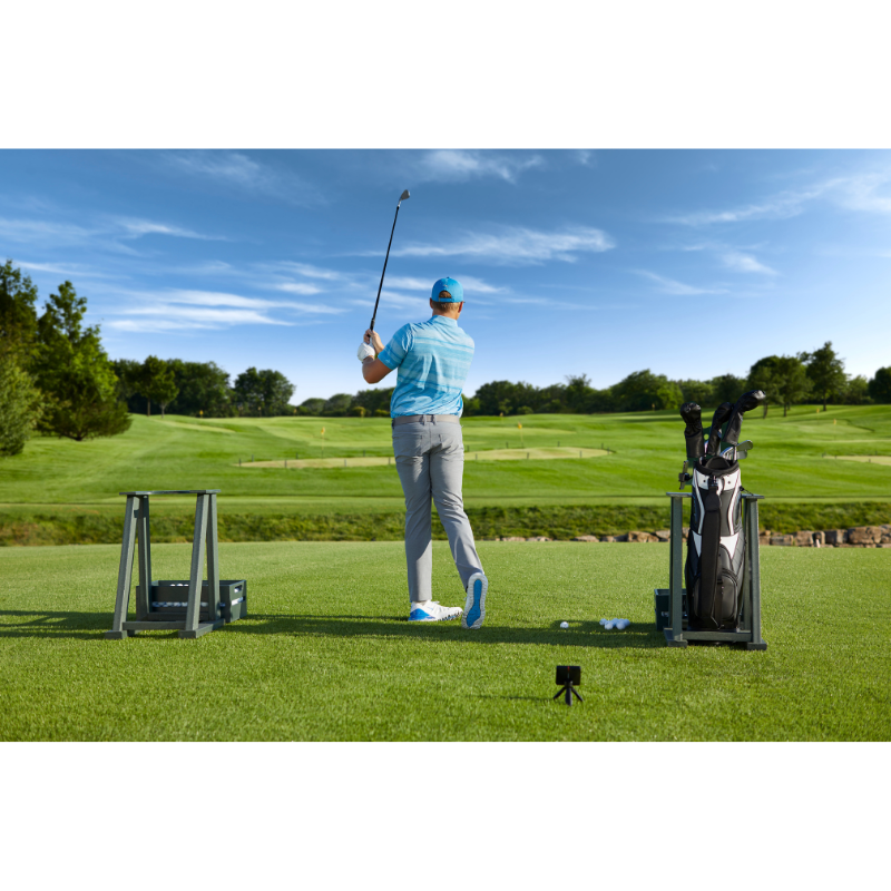 Garmin Approach R10 Launch Monitor with golfer on a driving range.