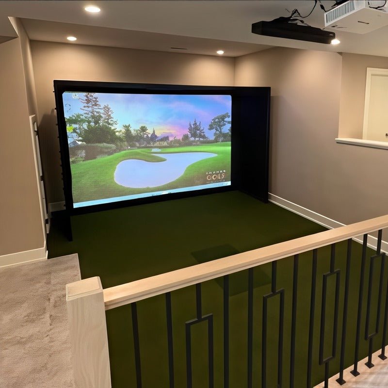 Golf Simulator Installation by Indoor Golf Outlet: a finished enclosure and turf floor in an open room, seen from the stairs.