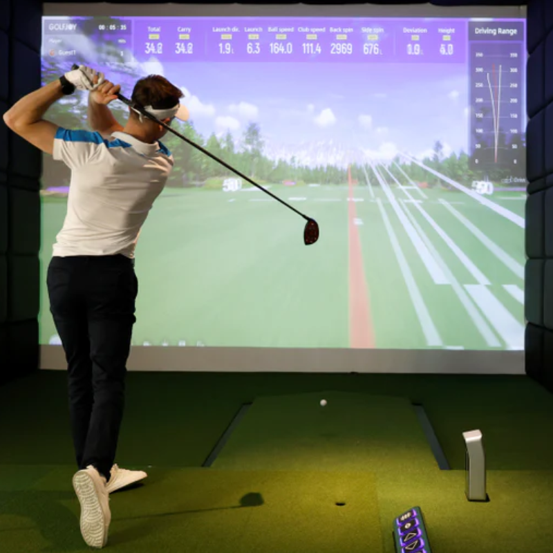 GolfJoy GDS Plus Launch Monitor and simulator with golfer.