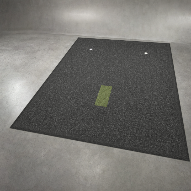 IGO Single-Level Golf Simulator Flooring in black, angled view of the turf, the green IGO Local Muni Hitting Strip and two putting cups.