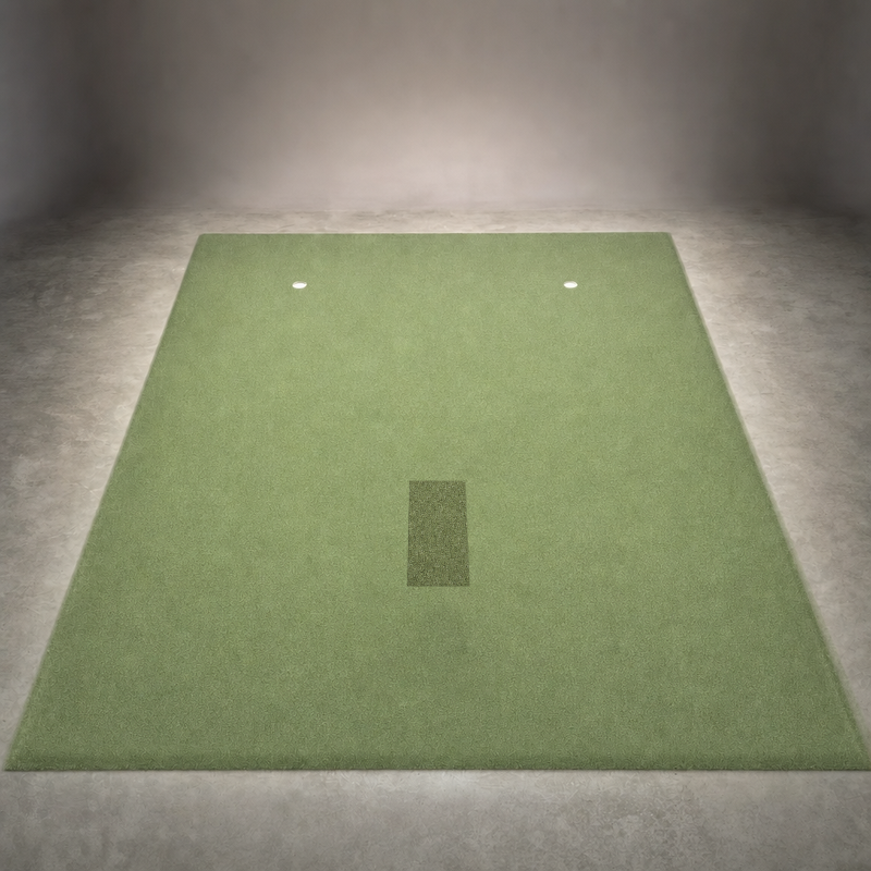 IGO Single-Level Golf Simulator Flooring in green laid out in a studio, with the IGO Local Muni Hitting Strip set flush in the turf and two putting cups.