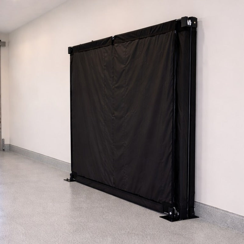 Impact Sports Foldable Golf Simulator Enclosure side view of the enclosure folded flat against the wall.