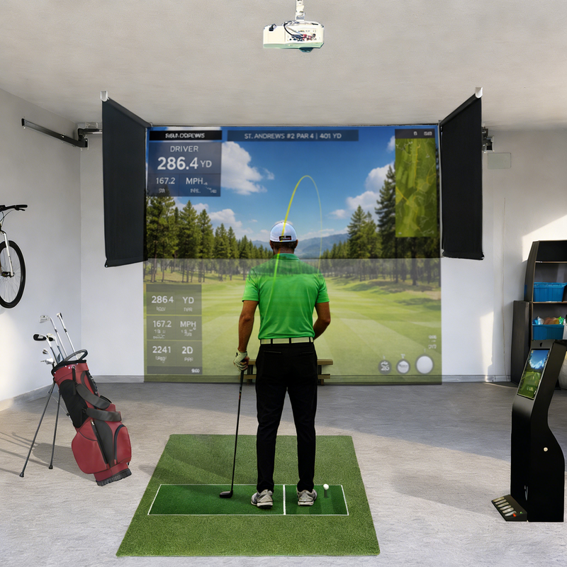 Impact Sports Motorized Drop-Down Golf Simulator Enclosure in a garage with a golfer at address and the course image on the screen.