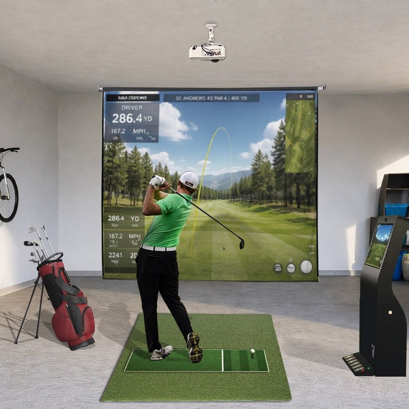 Impact Sports Motorized Retractable Golf Impact Screen lowered in a garage simulator bay with a ceiling projector and a golf course on the screen.