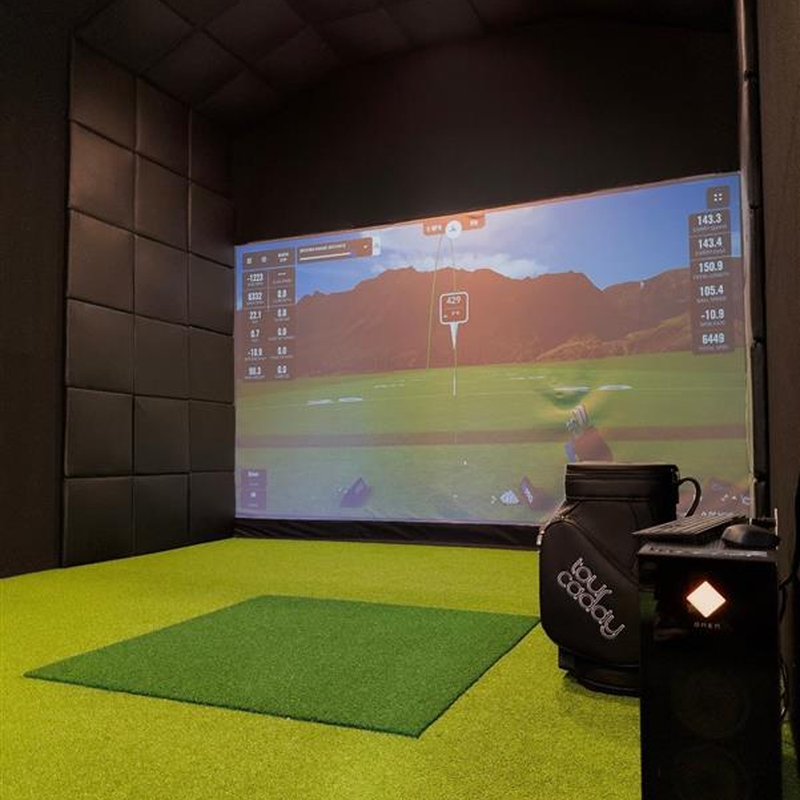 Impact Sports Premium Wall Padding (12-Pack) installed in a golf simulator bay with the pads mounted edge to edge on the side wall.