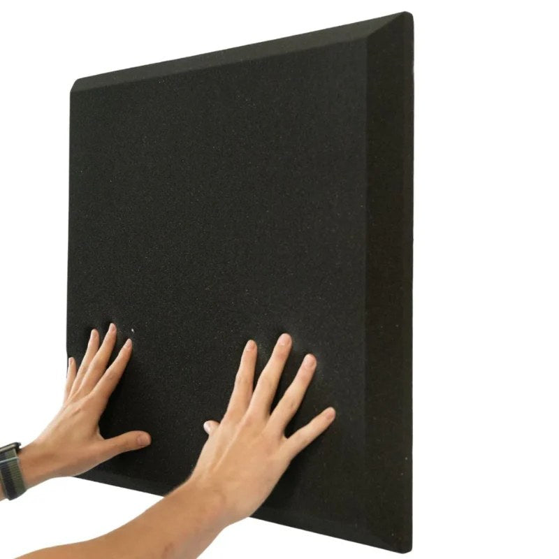 Impact Sports Standard Adhesive Wall Padding (8-Pack) black foam pad being pressed onto a wall by hand.