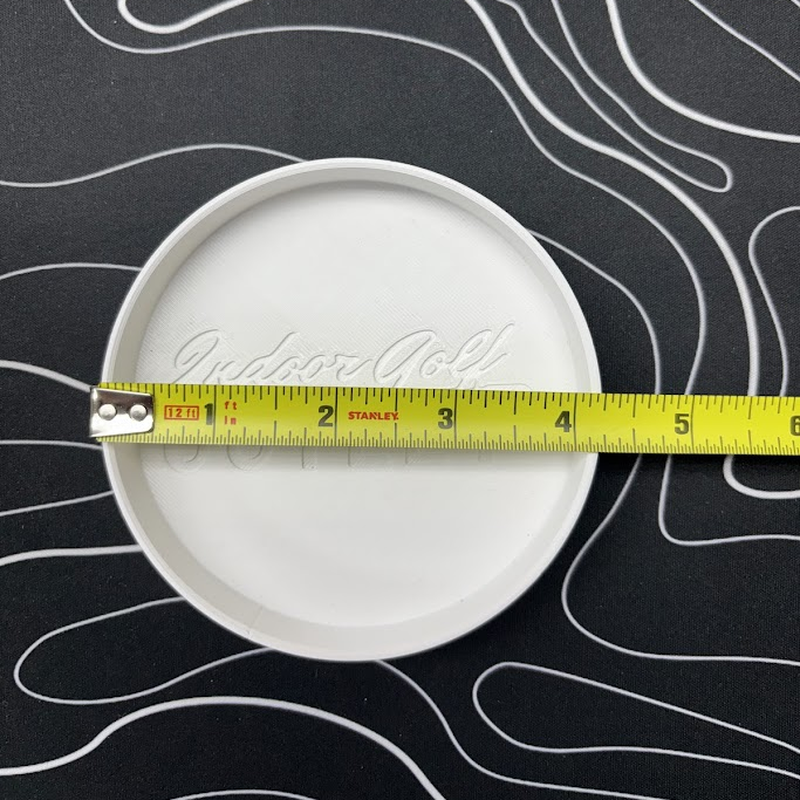 Indoor Golf Outlet Putting Cup shown at five inches in diameter with tape measure.
