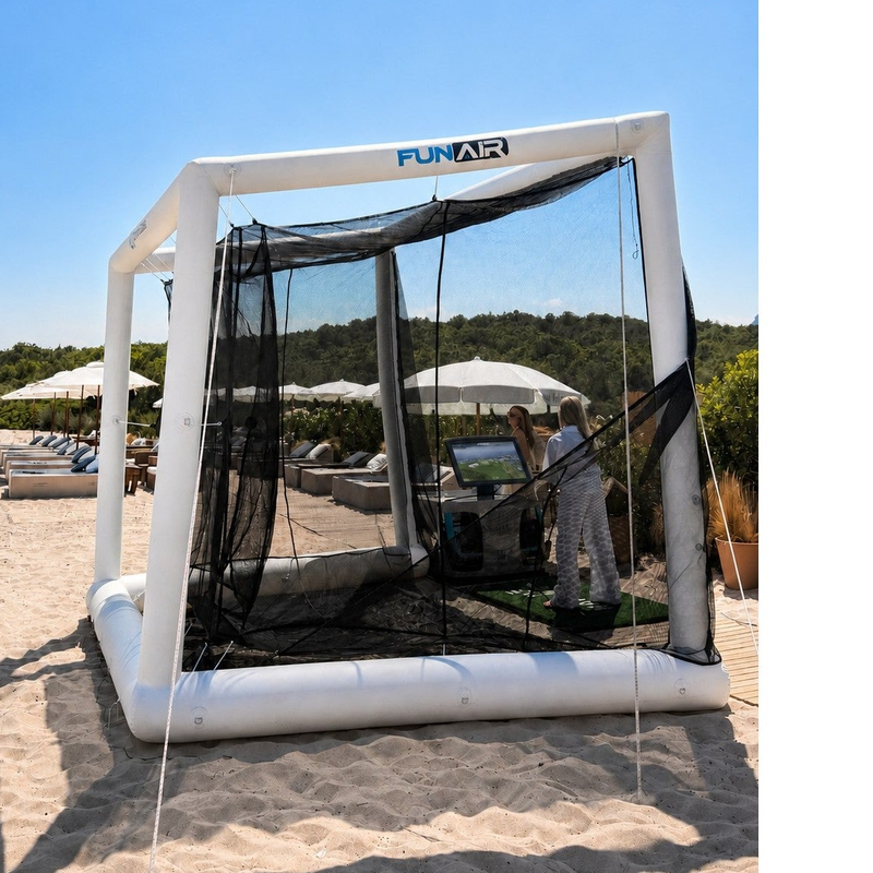 Off the Deck Cube Inflatable Golf Practice Net angled view on sand showing the inflatable cube frame, side netting and weight bag.