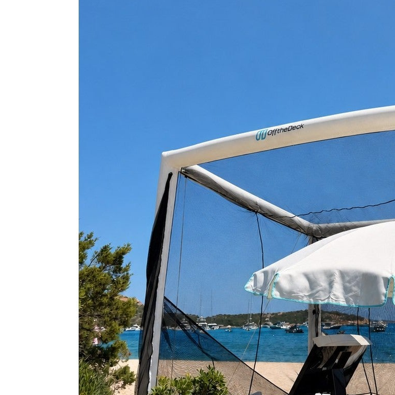 Off the Deck Cube Inflatable Golf Practice Net on a beach deck with a hitting station under a sun umbrella.
