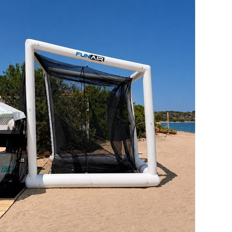 Off the Deck Cube Inflatable Golf Practice Net set up on a beach boardwalk, front view of the white inflatable frame and black netting.