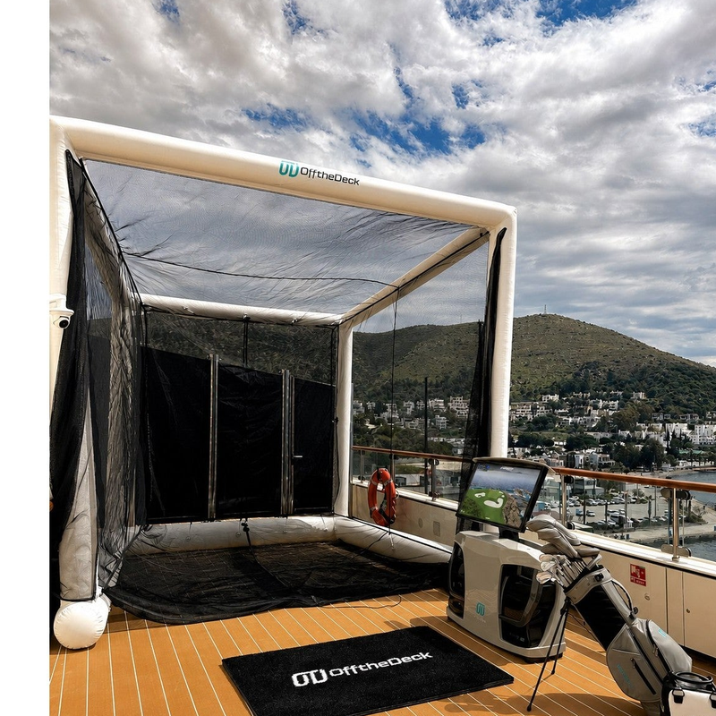 Off the Deck Cube Inflatable Golf Practice Net set up on a yacht deck with an Off the Deck hitting mat and simulator unit.