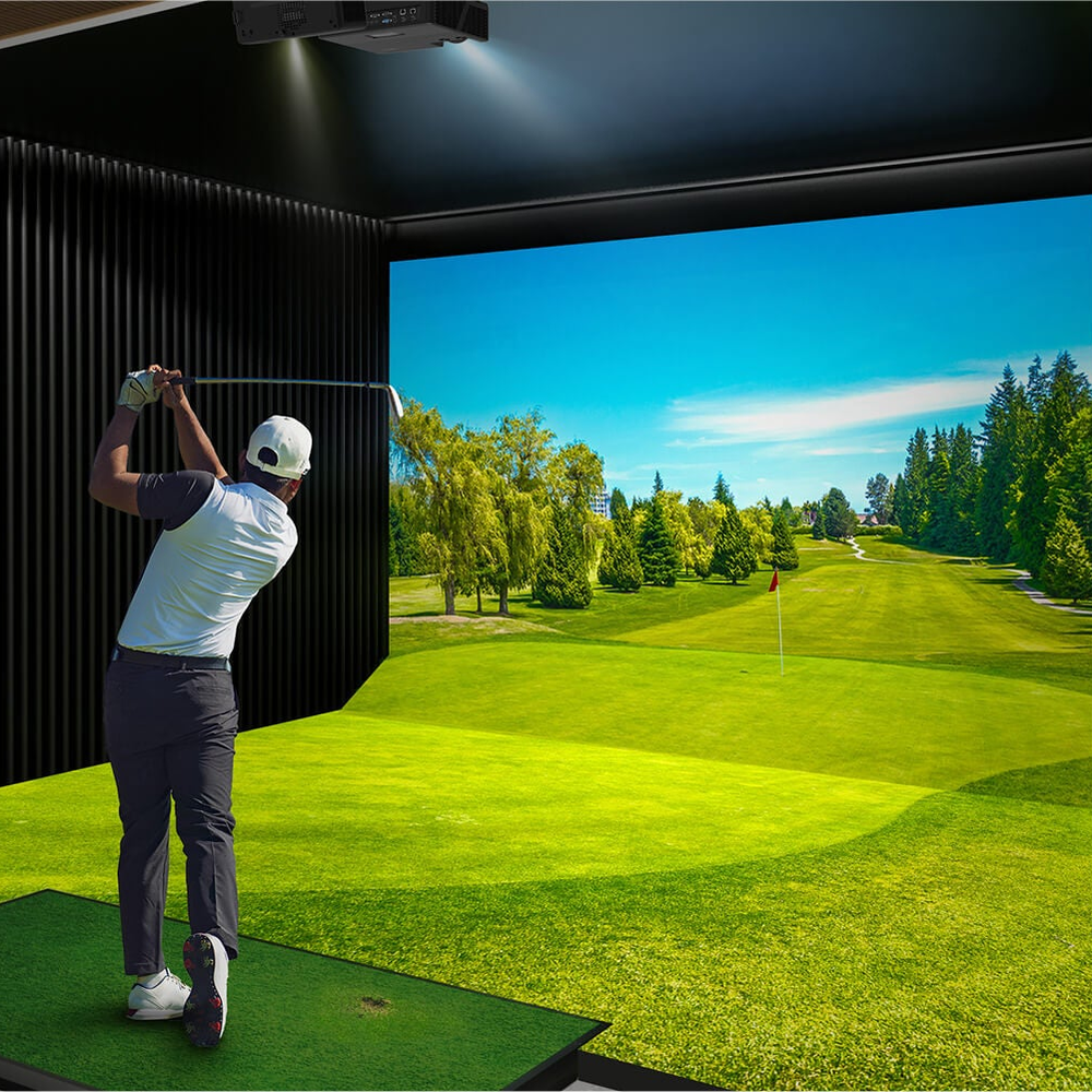 Golfer swinging in a golf simulator room with an Optoma short throw projector ceiling mounted