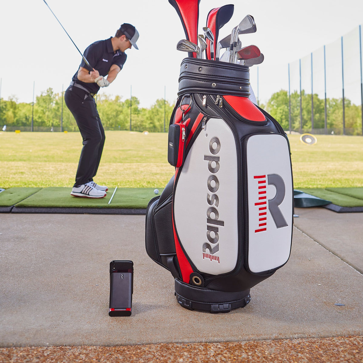 Rapsodo Mobile Launch Monitor with golfer on a driving range.