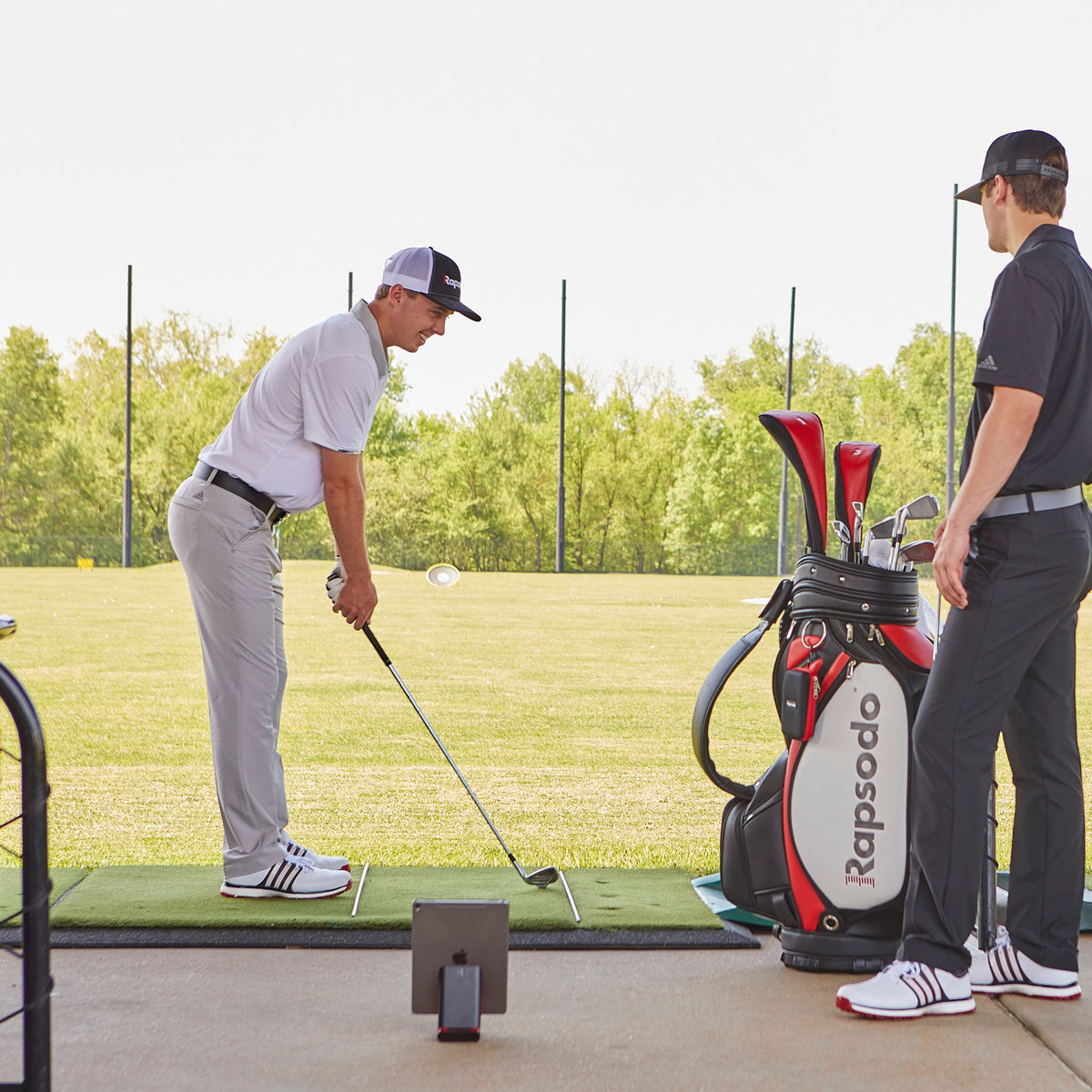 Rapsodo Mobile Launch Monitor being used with an iPad and by a golfer.