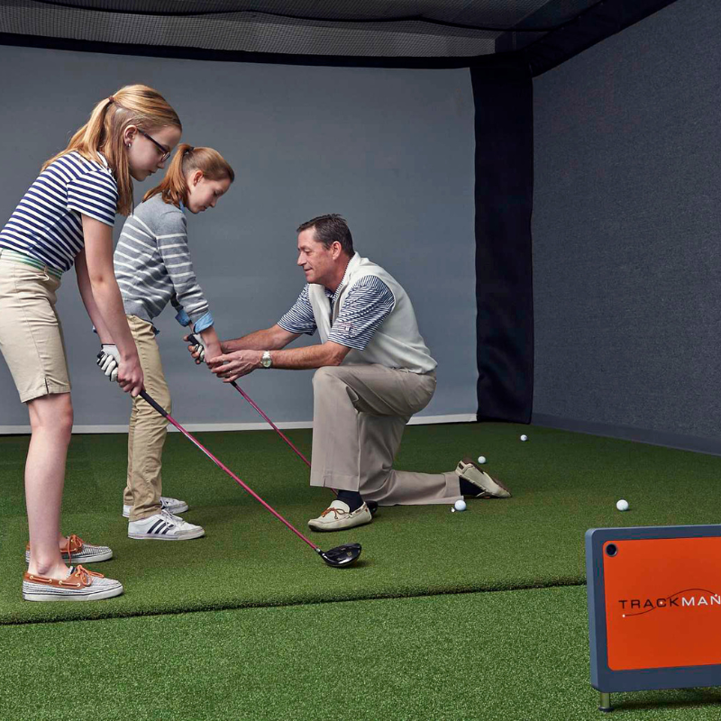 Real Feel Country Club Elite Golf Mat 5x8 foot inside a golf simulator with instructor teaching students.
