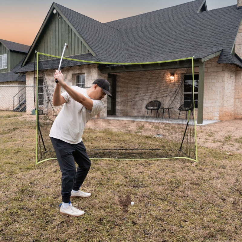 SIG 10&#39; x 7&#39; Rectangular Golf Hitting Net with golfer outdoors.