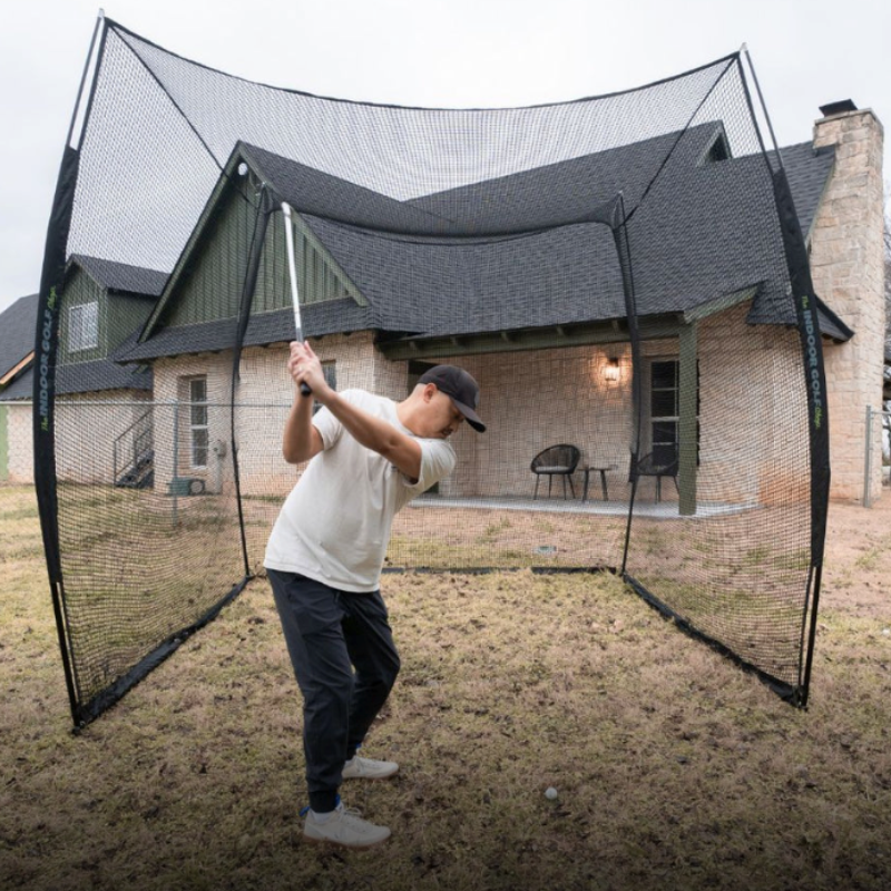 SIG 10&#39; x 10&#39; x 10&#39; Square Golf Net outdoors with golfer.