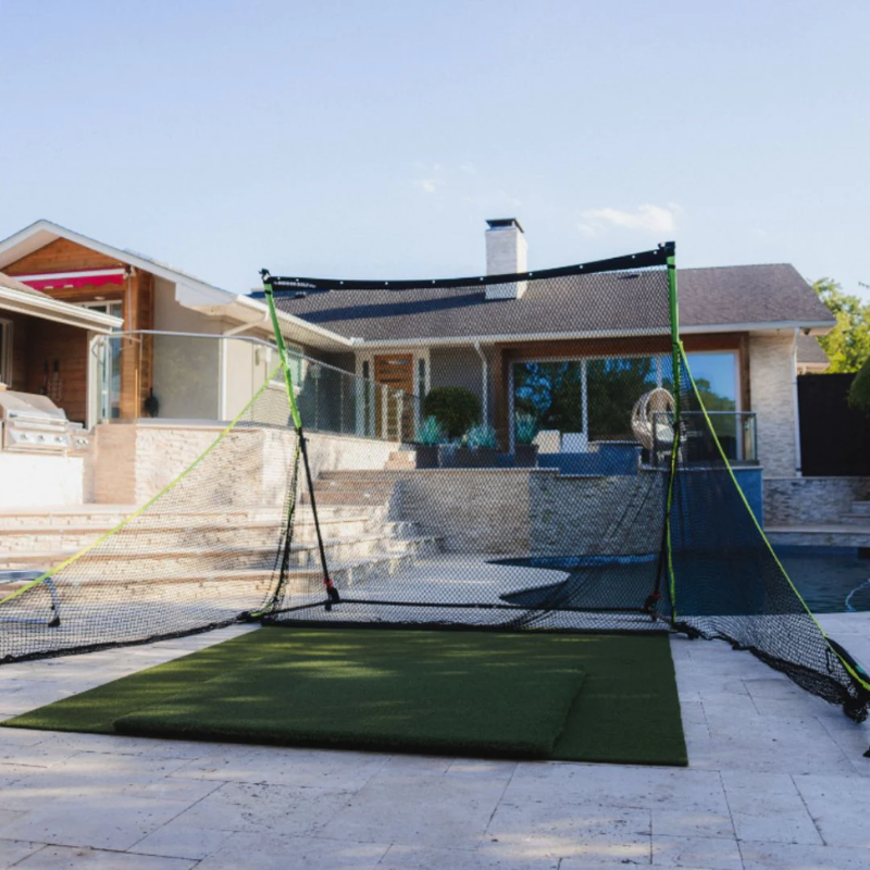 SIGPRO Golf Net in backyard with golf mat and pool.
