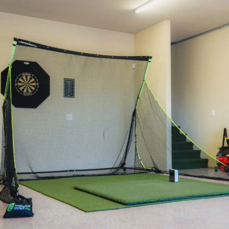 SIGPRO Golf Net in a basement with golf mat and launch monitor.