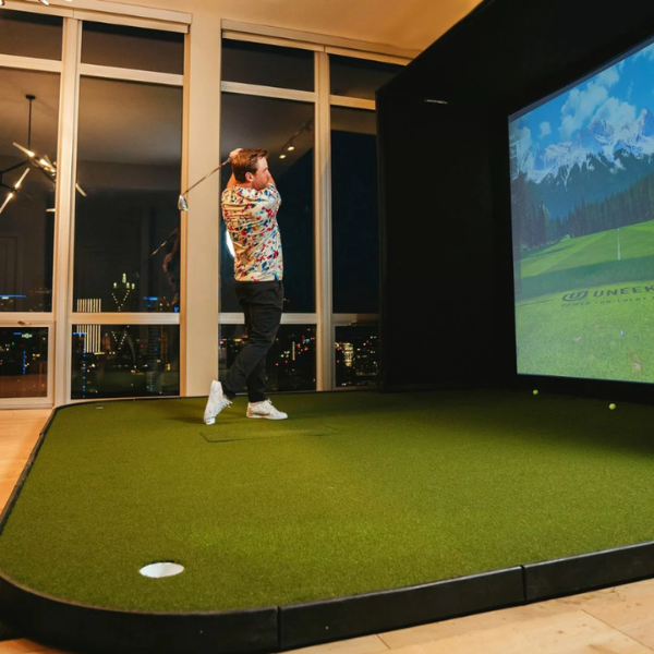 Golfer swinging on SIGPRO Golf Simulator Flooring.