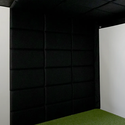 Carl's Place golf simulator impact screen with padded walls.
