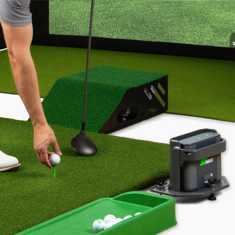 SkyTrak ST Max Golf Simulator Studio Package man putting ball on tee.