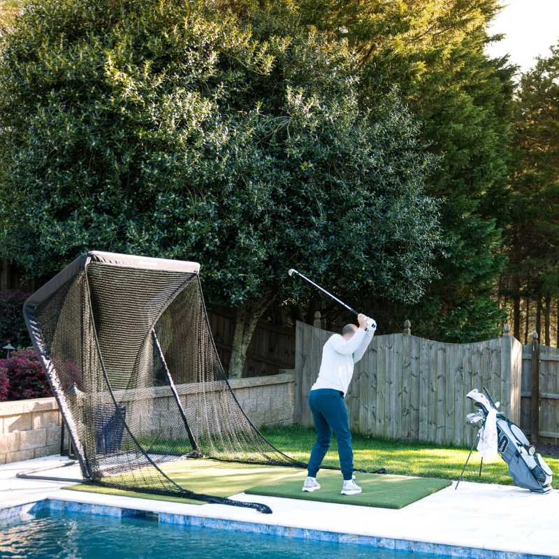 SwingNet Pro Golf Net side view with golfer practicing.