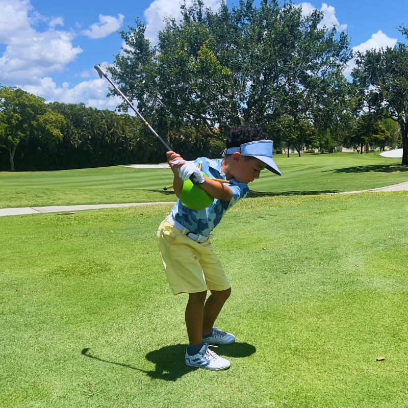 The Connector Jr. by Sure Golf with golfer in downswing.