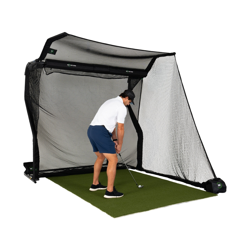The Net Return Pro No Fly Zone Package golfer practicing on the turf inside the net.