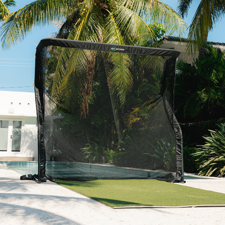 The Net Return Pro Series Golf Net with pool and house.