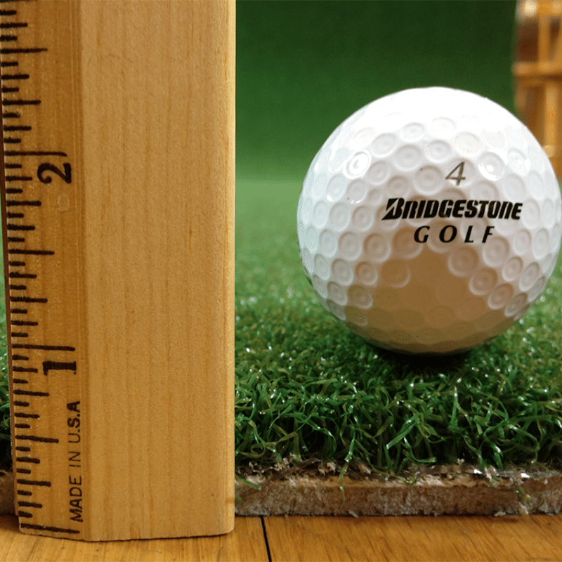 The Net Return Pro Turf thickness with ruler and golf ball.
