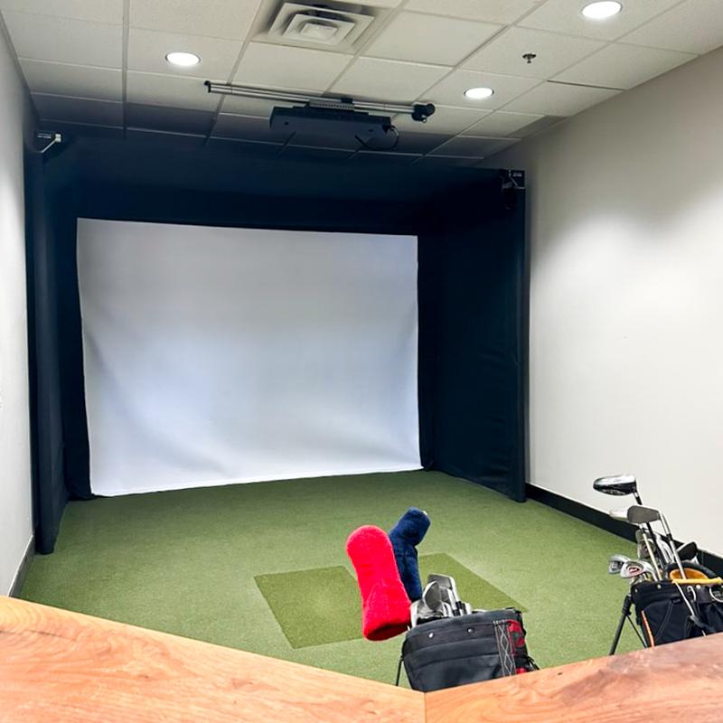 The SportScreen Parlour 11 Golf Simulator Enclosure side view with golf bags.