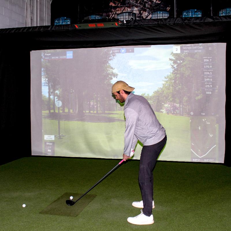 The SportScreen Parlour 16H Golf Simulator Enclosure golfer teed up in parlour 16