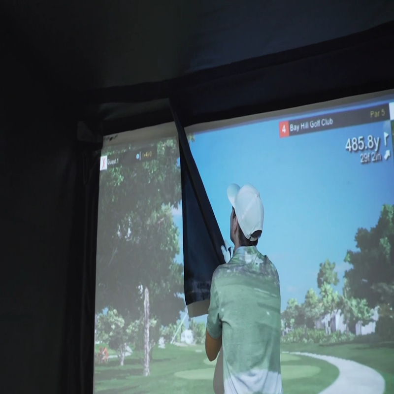 The SportScreen Vanish 11 Golf Simulator Enclosure man setting up.