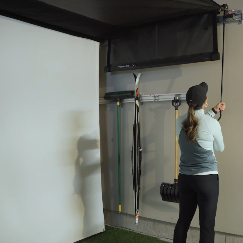 The SportScreen Vanish 16H Golf Simulator Enclosure women setting up