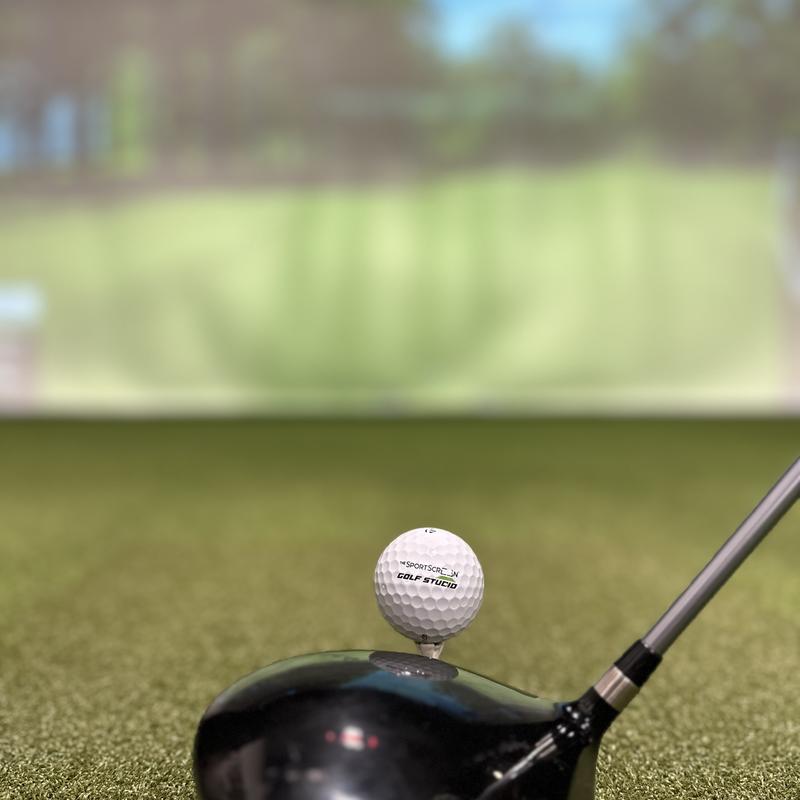 The SportsScreen Parlour Series Golf Simulator Enclosure closeup blurry background.