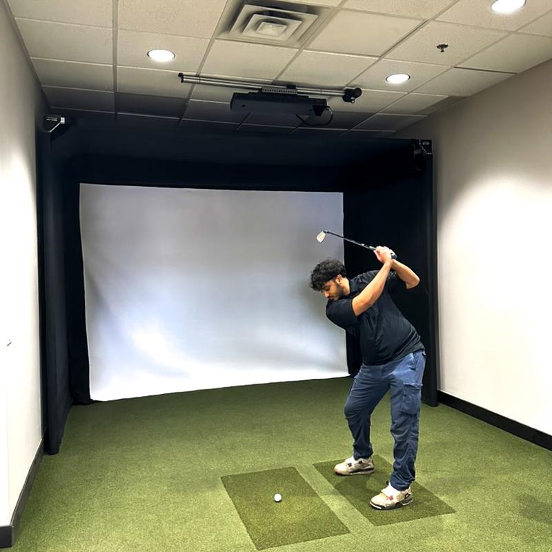 The SportsScreen Parlour Series Golf Simulator Enclosure golfer swinging.