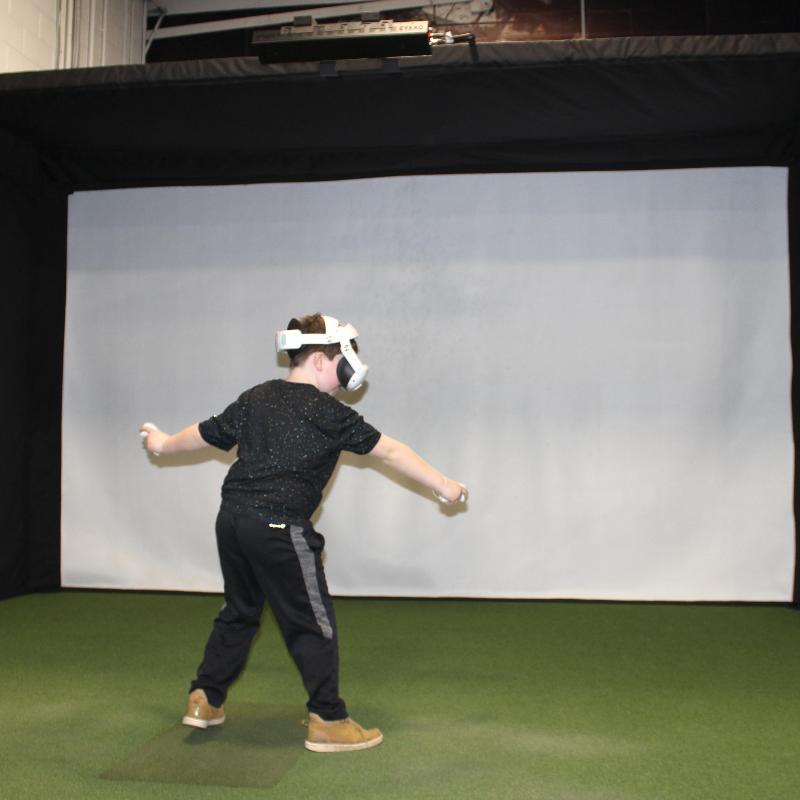 The SportsScreen Parlour Series Golf Simulator Enclosure kid using vr.