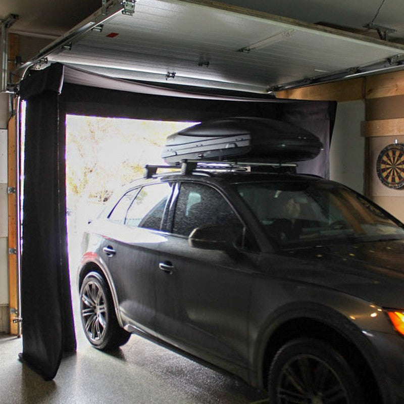 The SportsScreen Vanish LITE Series Golf Simulator Enclosure parked car in garage.