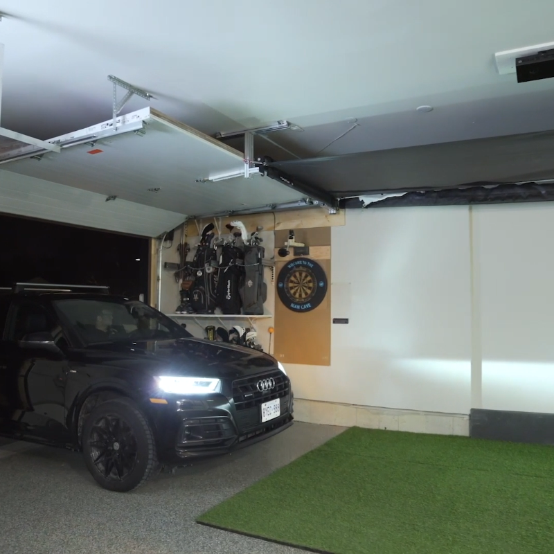 The SportsScreen Vanish Series Golf Simulator Enclosure car pulling in garage.