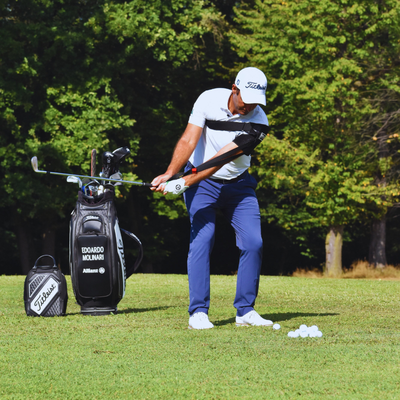 Tour-Feel Swing Trainer with golfer in backswing position.